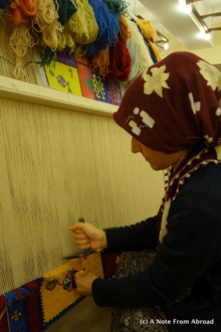 Wool carpet being knotted by hand